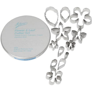 Ateco Tools 12-piece flower and leaf cutter set with brushes for crafting and cake decorating, displayed with various cut-out shapes and tools.