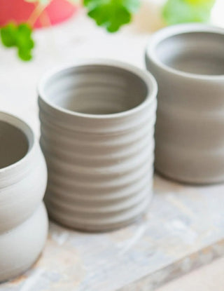 Unfinished clay art - ceramic art vases drying before glazing and firing