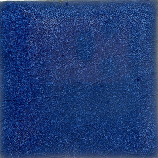 Coyote Glazes ceramic glaze in Lazurite color displayed on a tile, showcasing vibrant blue and deep glaze effects for pottery projects.