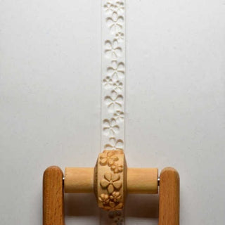 MKM RS 024 small handle roller with embossed floral pattern, used as a pottery texture tool for creating decorative effects.