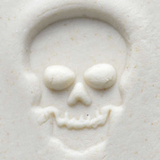 MKM SCM 106 Medium Round Skull Stamp for pottery texture tools, showing the stamped skull design on clay surface.