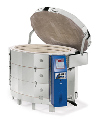 Cone Art GX4227D oval kiln package with furniture and integrated venting, showing the kiln and accessories in a workshop setting.