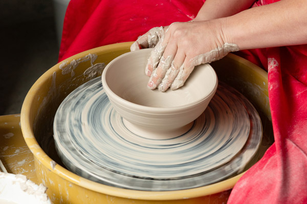 mass white pottery clay on potters wheel